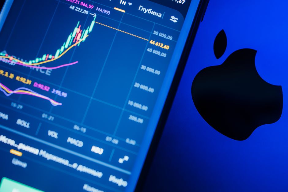 Close-up of a stock market app with charts and branding on a digital device screen.